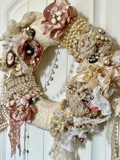 This is sold. contact me for your very own custom wreath or purchase this one and I will create one similar.  This one has pink accents. Turnaround time is approximately two weeks. This shabby chic wreath is adorned in vintage and new items. Including lace, rhinestones, pearl strands, handmade flowers, costume jewelry, etc. All in whites and cream tones. Items are one of a kind.  For indoors.  Wreath is on a 12" base Shabby Chic Design Interior, Shabby Chic Wreath Ideas, Rag Wreath Ideas, Doily Wreath, Boho Wreaths, Shabby Chic Fireplace, Flowers Costume, Shabby Wreath, Shabby Chic Garland