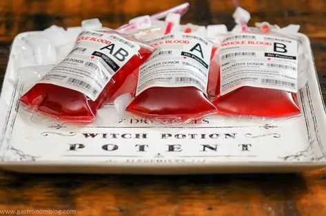 21 Amazing Halloween Drinks For A Crowd - Crispyfoodidea Iv Bag Drinks, Blood Cocktail, Halloween Party Punch, Spooky Drinks, Spooky Cocktails, Passion Fruit Tea, Blood Bag, Bread Booze Bacon, Fun Drink Recipe