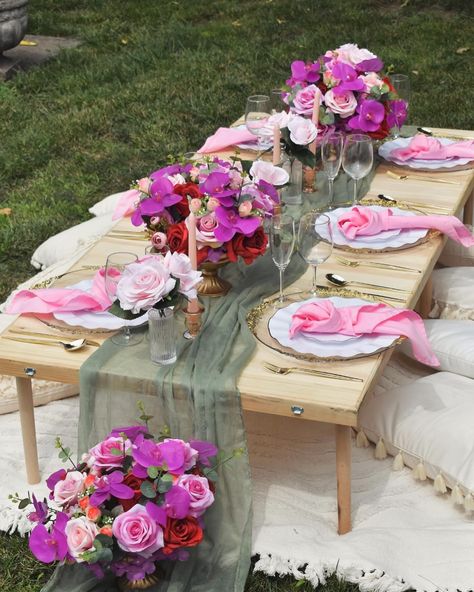 The vibrant floral arrangements, blending shades of pink, purple, and red, lend a timeless elegance to this tablescape, making it a perfect centerpiece for any luxury outdoor picnic setting. * * * Silk Floral Rental : @brooklynsilkblooms #LuxuryPicnic #PicnicGoals #LuxuryOutdoorDining #PicnicInStyle #LuxuryExperience FloralRentals #LuxuryFloralRentals #EventFlorals #FloralDesign #EventDecor #luxuryflorals Picnic Styling, Picnic Setting, Picnic Style, Luxury Event, Outdoor Picnic, Outdoor Picnics, Shades Of Pink, Shades Of Purple, Celebration Of Life