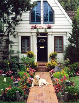 A brick walkway to the front door of a house with a dog laying on the walkway Front Walkways, Front Door Landscaping, Sidewalk Landscaping, Front Yard Walkway, Front Path, Walk Idea, Walkway Landscaping, Front Walk, Brick Walkway