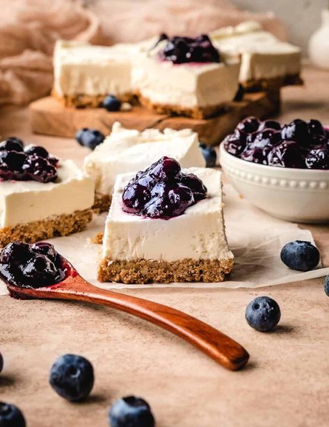 THESE EASY BLUEBERRY GOAT CHEESE CHEESECAKE BARS COME TOGETHER SUPER QUICKLY. WITH A CREAMY, SLIGHTLY TANGY NO BAKE CHEESECAKE FILLING, LOADS OF BLUEBERRIES ON TOP AND A SALTY PRETZEL CRUST, YOU’LL LOVE EVERY BITE OF THESE SWEET AND SALTY, LUSCIOUSLY CREAMY DESSERT BARS! Veering from the commonly used graham cracker crust and instead using a salty pretzel crust, these Blueberry Goat Cheese Cheesecake Bars are anything but ordinary. Add to that a bit of goat cheese for a wonderful and delightful Goat Cheese Cheesecake Recipe, Goat Cheese Cheesecake, Blueberry Sauce Recipe, Blueberry Goat Cheese, Cheesecake Bars Easy, No Bake Cheesecake Filling, Goat Milk Recipes, Baking Photography, Baked Goat Cheese