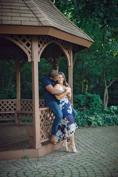 Shelby Township Michigan Garden Engagement embrace smiling, maurice sitting on gazebo ledge and genevieve standing Photo: Holly Green Gazebo Pictures, Michigan Garden, Michigan Gardening, Evening Garden, Central Michigan University, Garden Engagement, Engagement Pictures Poses, Couples Engagement Photos, Photographs Ideas