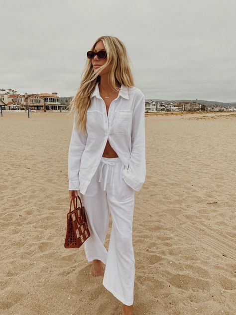 A woman dressed in a comfy and chic summer outfit barefoot at the beach. The button-up shirt and matching pant set is made of a textured soft cotton, and is worn half buttoned up for an effortlessly chic vibe. White Gauze Shirt Outfit, Gauze Shirt Outfit, Gauze Pants Outfit, Gauze Outfit, 2024 Inspiration, Gauze Pants, Gauze Shirt, Wardrobe Refresh, Soft Summer