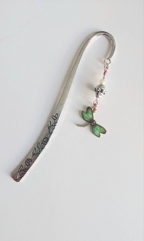 "This silver tone metal bookmark has a lovely floral pattern engraved on both sides of the hook. I added beads and a lovely enamel dragonfly charm for an elegant garden theme. I create my bookmarks by searching for cute and creative metal pre-made book hooks. I add embellishments such as charms and/or resin bits that I make. Though I create *multiples of some designs, there are usually only 3 available at a time.  If materials are available, I sometimes make more. Each bookmark is placed on the Quote Books, Elegant Garden, Green Dragonfly, Dragonfly Charm, Floral Card, Metal Bookmarks, Garden Theme, Cosmetic Storage, Floral Cards