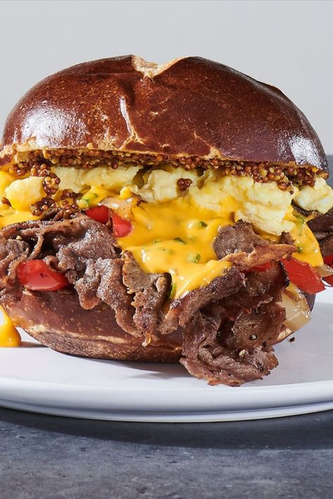 One of our favorite LTOs: the Philly Biergarten Steak & Egg Breakfast Sandwich. Egg Breakfast Sandwich, Burger Sliders Recipes, Beer Cheese Sauce, Steak Breakfast, Egg Sandwich Breakfast, Philly Steak, Best Sandwich Recipes, Fluffy Scrambled Eggs, Pretzel Bun