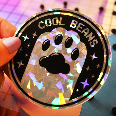 These holographic stickers are perfect for adding a touch of sparkle to your notebooks, laptops, or water bottles. They're also great for giving as gifts! #holographicstickers #coolbeans . #Cute_Cricut_Stickers #Holo_Stickers #Paw_Sticker #Vinyl_Paint Cute Cricut Stickers, Holo Stickers, Paw Sticker, Cool Beans, Vinyl Painted, Stickers Cool, Sticker Design Inspiration, Packaging Ideas Business, Holographic Stickers