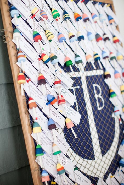 Nautical wedding place settings for guests. Hand painted mini buoys for guests to have as ornament/keychain keepsakes hung on a painted cork board. Inspired by Pinterest Table Assignments Wedding, Painted Cork Board, Nautical Wedding Inspiration, Provincetown Massachusetts, Edgy Bridal, Carmel Weddings, Table Assignments, Beach Wedding Centerpieces, Ocean Wedding