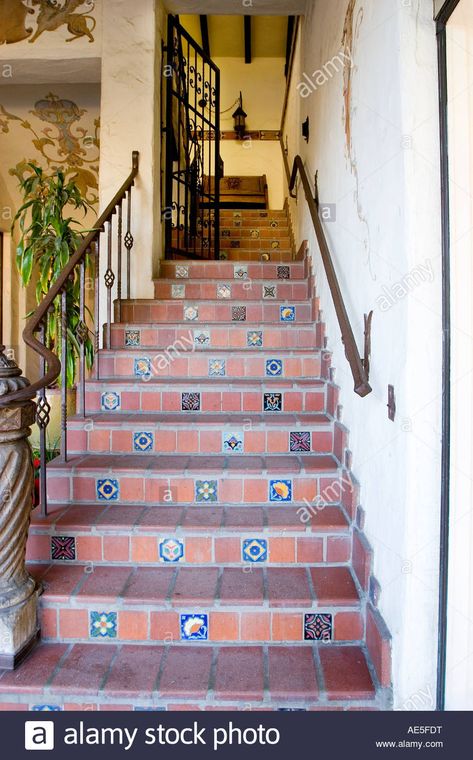 Spanish style staircase with terra cotta and decorative tiles with wrought iron railing and gate Stock Photo Tiled Staircase, Stucco Homes, Tile Stairs, Spanish Tile, Iron Railing, Spanish Revival, Spanish House, Decorative Tiles, Terracotta Tiles