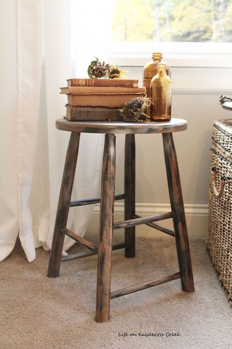 Most of the fun in decorating for me comes from trying to find interesting pieces that give our home character. I guess that’s why I love vintage and antique pieces so much because they are usually worn in such a perfect way and have a great patina.One of the things that I’m drawn to is the look of these old fashioned farmhouse milking stools. They are great for adding height to your vignettes and character to your space. I decided to make one out of a plain wooden kitchen stool. Her… Old Fashioned Farmhouse, Diy Wallpaper Headboard, Diy Upholstered Storage Bench, Wooden Kitchen Stools, Cleaning Marble Floors, Wallpaper Headboard, Home Character, Bar Stool Makeover, Farmhouse Style Curtains