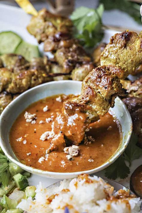 Indulge in this delicious Authentic Pork Satay, marinated in flavorful spices, grilled or baked to perfection, and served with a mouthwatering creamy peanut dipping sauce. Enjoy every savory bite! #porksatay #satay #grilledsatay #thaisatay #satayrecipes #authenticporksatay #authenticsatay #thaisatayrecipes Thai Side Dishes, Authentic Thai Recipes, Pork Satay, Thai Recipes Authentic, Beef Satay, Thai Pork, Satay Recipe, Peanut Dipping Sauce, Pork Skewers