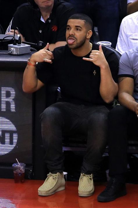 Drake wearing Ovo Pom Pom Crewneck and Clarks Suede Wallabee Boots in Maple Clark’s Outfits Men, Mens Clarks Wallabees Outfit, Clarks Men Outfit, Clarks Wallabees Men Outfit Mens Fashion, Clark Wallabees Men Outfit, Clarks Wallabees Men Outfit, Clark Wallabees Outfit, Wallabees Outfit Men, Drake Fits