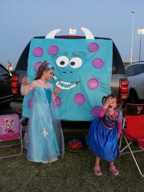 Sully Monsters Inc Trunk or Treat for under $3. Blue plastic tablecloth folded. Purple paper plates glued on. Eyes, horns, and teeth made from white poster board. Used large permanent marker to draw mouth, nose,  and eyebrows. #trunkortreat #sully #monstersinc #halloween #decorating Monsters Inc Trunk Or Treat, Sully Monsters Inc, Monster Inc, Elegant Centerpieces, Plastic Tablecloth, Trunk Or Treat, Monster Party, Monsters Inc, White Candles