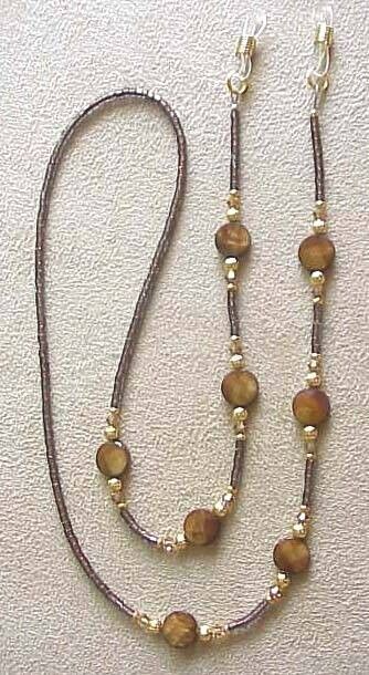 THIS EYEGLASS CHAIN IS A BEAUTIFUL COLOR TO ACCENT THOSE READING GLASSES OR SUNGLASSES, IT IS APPROX 29" LONG AND IT STRUNG ON 49 STRAND NON KINKING NYLON COATED 49 STRAND WIRE, THIS EYEGLASS CHAIN IS DONE WITH BROWN SHIMMERING MOTHER OF PEARL 8MM square BEADS ( picture shows round but these are just as pretty but square and faceted)WITH MATCHING FINE EUROPEAN  CRYSTALS. IT RETAILS FOR $48 IN GIFT SHOPS. THANKS FOR LOOKING  AND THERE ARE LOTS MORE IN MY EBAY STORE,  !!! Beaded Eyeglass Chain, Eyeglass Jewelry, Kalung Manik-manik, Eyeglass Chain Holders, Eyeglass Chains, Eyeglass Necklace, Diy Jewelry Necklace, Mask Chain, Pola Gelang