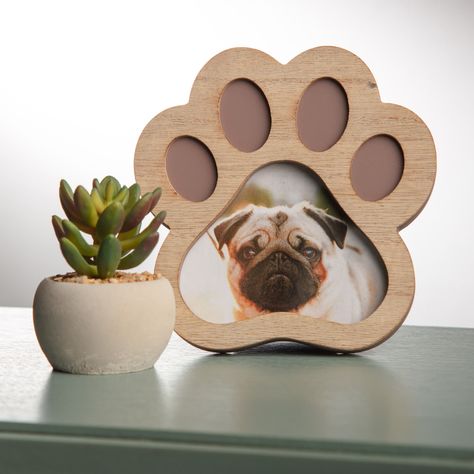 "Find 4\" x 4\" Natural Woodgrain Paw Shape Frame by Studio Décor® at Michaels. Showcase a cherished memory in this simple and beautiful frame. Showcase a cherished memory in this simple and beautiful frame. You can place it on your accent table with other frames to create a lovely and striking display. Details: Brown 4\" x 4\" (10.1cm x 10.1cm) image size 5.5\" x 5.5\" x 0.6\" (14cm x 14cm x 1.5cm) overall size Glass thickness: 1.8 mm Fold-out easel attached MDF and glass | 4\" x 4\" Natural Wo Dog Mom Clothes, Paw Print Shadow Box Ideas, Dog Picture Frame, Wood Paw Print, Framed Dog Paw Print, 4 Picture Frame, Wooden Dog Memorial Sign, Dog Picture Frames, Laser Cut Mdf