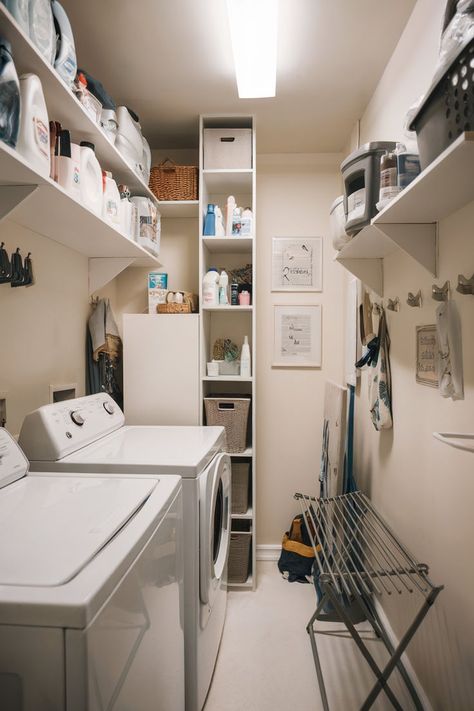 A narrow laundry room with shelves, organized storage, and practical space-saving solutions to maximize functionality. Small Narrow Laundry Room, Small Narrow Laundry Room Ideas, Washer And Dryer Shelves, Small Laundry Room Decor Ideas, Small Laundry Room Decor, Narrow Laundry Room Ideas, Narrow Laundry, Small Laundry Room Ideas, Narrow Laundry Room