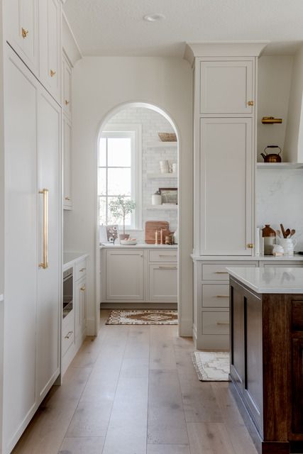 Kitchen features a pantry with an arched doorway. White Kitchen Pantry Cabinet, Dutch Cottage, White Kitchen Pantry, Kitchen Canopy, Arched Doorway, Pantry Cabinets, Butlers Pantry, Project Portfolio, Kitchen Pantry Cabinets