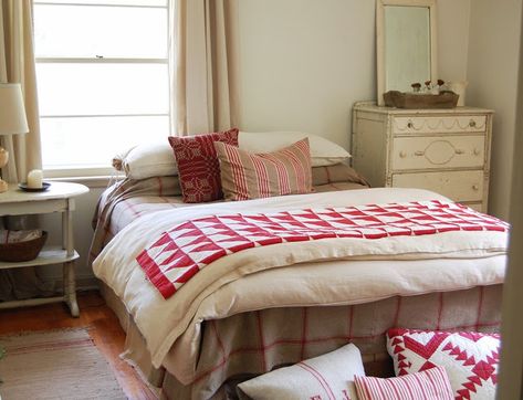 It's OK to put a bed in front of a window, even if it's off-center. In this example, the window is balanced by the tall dresser on the other side. Besides, with such pretty linens, who's looking at anything else? Off Center Windows, Happy Bedroom, Traditional Bedside Tables, White Bench, Red And White Quilts, Bedroom Windows, Down Comforter, Parade Of Homes, Bedroom Layouts