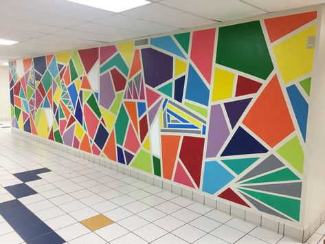 Painted geometric wall mural in an elementary school. Took 3 days and we used Valspar paint with painters tape. The kids and staff love it! Mural School, Easy Wall Painting Ideas, Easy Wall Painting, School Wall Art Ideas, Wall Painting Ideas, School Wall Art, School Murals, School Painting, Wall Murals Painted