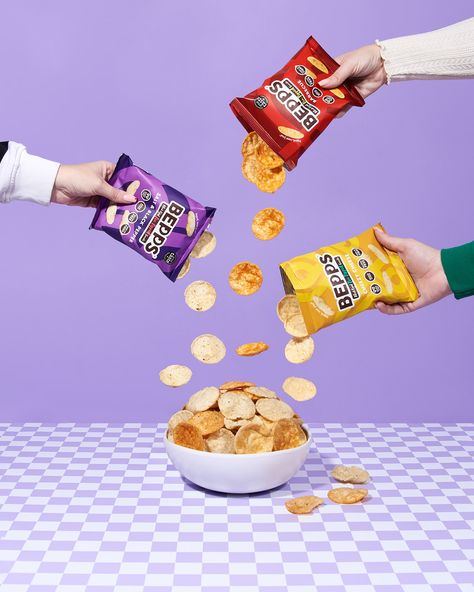 Pouring pop crisps from Bepps snacks displaying three flavours of their pea popped chips. Lilac and checkerboard aesthetic. Food Photography Snacks, Chips Lifestyle Photography, Product Photography Food Packaging, Food Package Photography, Chips Product Photography, Product Photography Ideas Food, Snack Photography Ideas, Lifestyle Photography Product, Candy Photography Food Styling