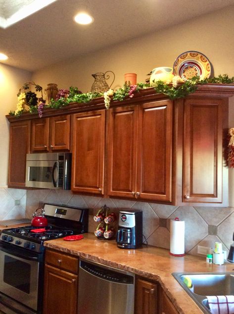 Decorating above the kitchen cabinets. Flowers Above Kitchen Cabinets, On Top Of Cabinet Decor, Decorating Over Kitchen Cabinets, Classy Kitchen Decor, Above Cupboard Decor, Top Of Refrigerator Decor Ideas, Decorate Top Of Kitchen Cabinets, Top Of Kitchen Cabinet Decor, Decor For Top Of Kitchen Cabinets