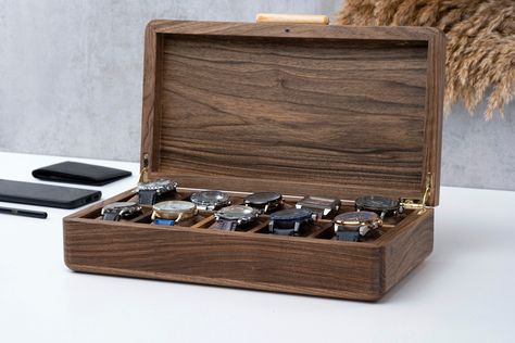 "Completely handmade from natural solid walnut wood that will accompany you for many years, this luxury watch box has 8 or 10 separate watch slots and free handmade luxury velvet fabric cushions to organize, display and store your watches. While providing both a more aesthetic appearance and a timeless design by rounding the sharp edges, we also achieved a stylish design with the handmade ash handle that matches the general appearance of the box. The door has stylish metal hinges that prevent it Luxury Watch Box, Watch Box For Men, Wood Watch Box, Engraved Watch, Mens Watch Box, Watch Storage Box, Watch Engraving, Watch Holder, Watch Storage