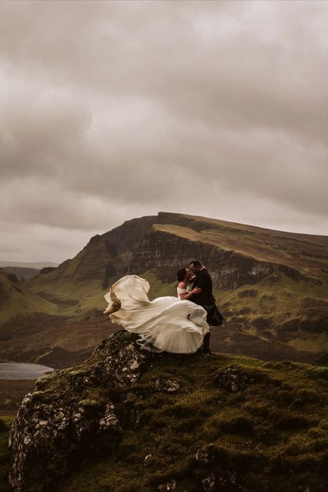 A wedding couple is kissing each other on top of a cliff. Scotland Wedding Photography, Wales Elopement, Mountain Elopement Photos, Mountain Elopement Dress, Glencoe Elopement, Mountain Wedding Dress, Moody Elopement, Wedding Scotland, Ireland Elopement