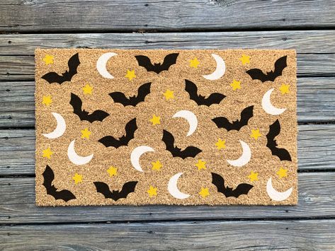 Make an impression on your guests and trick-or-treaters before they walk in the door!  This hand-painted doormat is the perfect addition to your halloween and fall decor.  *Colors may slightly vary from what is on screen. Listing is for doormat only; layering rug not included. ✨About the product✨ - As of right now, our doormats come in one standard size, 30" wide x 18" tall  - These indoor/outdoor mats are made of durable, all natural coir (coconut fiber) bristles with a vinyl backing to avoid s Diy Door Mat Halloween, Halloween Door Mats Diy, Diy Outdoor Mat, Spooky Mats, Halloween Welcome Mats, Halloween Door Mat Diy, Fall Door Mats Diy, Diy Halloween Doormat, Halloween Mat