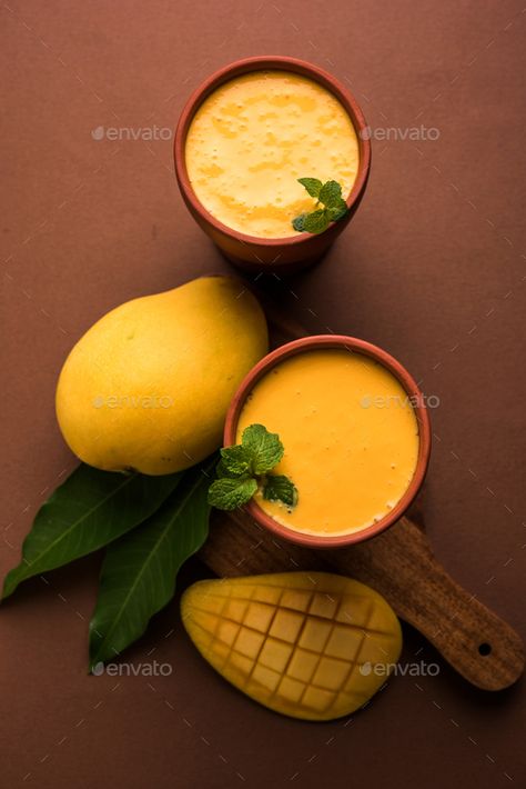 Mango Lassi by stockimagefactory. Mango Lassi, Indian popular summer cold drink from India made using Alphonso or Hapus aam #Sponsored #Indian, #popular, #summer, #Mango Alphonso Mango, Textures Art, Mango Lassi, Cold Drink, Bottle Design, Cold Drinks, Mantra, Food Photography, Mango