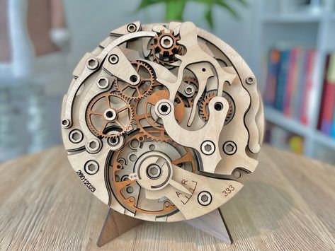 My adoration for mechanical watches goes beyond their metallic casing; it's the intricate inner workings that truly captivate me. To pay homage to this fascination, I designed an art piece inspired by various mechanical watches. Constructed from multiple layers of wood, this artwork boasts a diameter of 305mm. Its one-of-a-kind multilayer mandala design makes it a striking addition to any living space, be it as home decor or wall art. This piece also serves as a thoughtful and original gift for Mechanical Watch Movement, Mandala Decoration, Cnc Machine Projects, Watch Wood, Basic Sketching, Wood Laser Ideas, Watch Art, Gear Clock, Mechanical Clock