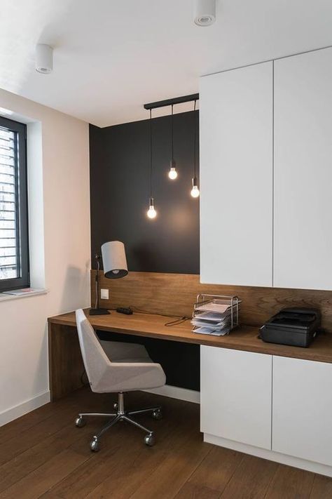 a small and functional home office with a black accent wall, sleek white storage units, a built in desk and a white chair plus bulbs hanging Apartemen Studio, Bilik Idaman, Desain Pantry, Home Office Table, Home Office Inspiration, Office Nook, Bilik Tidur, Office Layout, Trendy Living Rooms