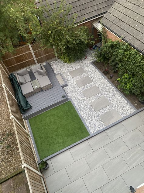 Stepping stones with large porcelain slabs and fake grass, a room for plants with a bed at the side. Garden With Slabs And Decking, Garden Ideas Stones, Fake Grass Patio, Fake Grass Garden Ideas, Garden Slabs Ideas, New Build Garden Ideas, Fake Grass Backyard, Room For Plants, Garden Slabs