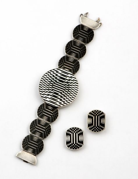 Victor VASARELY  (Hungary 1906-1997)  Jolie, c. 1985  Sterling silver bracelet and matching earrings decorated with mathematical precision in black and mother of pearl enamel to create a design with the same moving and optical illusions found in the rest of his art. Circle of Fine Art, 113/250 Bracelet: 4 x 15.9 cm Earrings: 2.3 x 1.8 cm Optical Illusion Jewelry, Victor Vasarely, Abstract Jewelry, Jewelry Illustration, Art Circle, 1st Year, Enamel Bracelet, Snow Jacket, Contemporary Jewelry