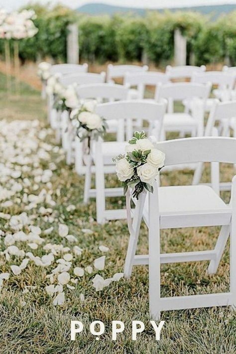 All white wedding decor is a classic wedding theme with inspiration from traditional wedding flowers. Use flower petals as a wedding aisle runner with white wedding arrangements on each wedding aisle chair. Bulk white wedding flowers can come to life when you’re wedding planning on a budget (or not!) with Poppy. White Roses Ceremony Aisle, White Wedding Chair Decorations, White Wedding Flowers Isle, Flowers On Aisle Chairs, Minimalist Wedding Ceremony Outdoor, Wedding Ceremony Outdoor Decorations, Simple Outdoor Aisle Decor, White Rose Isle Wedding, Wedding Chair Florals