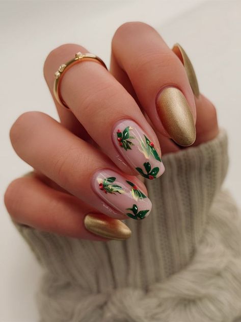 This sophisticated holiday nail design features a satin gold finish on almond-shaped nails, contrasted with delicate holly leaf and berry details on a neutral base. Perfect for those seeking a festive yet understated look, this design combines elegance with seasonal charm. Wreath Nail Design, Neutral Holiday Nails Almond, Satin Nails, Holly Nails, Holiday Nail Designs, Shaped Nails, Holiday Nail, Almond Shaped, Gold Satin