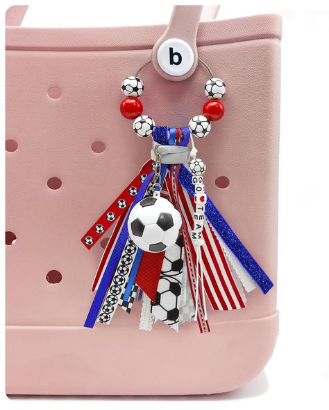 PRICES MAY VARY. Elevate Your Style with Soccer Chic: Our Bogg Bag accessory combines with a trendy tassel made from different ribbons, a soccer ball charm, and eye-catching wooden beads. This handmade bogg bag charm instantly adds a touch of soccer chic to any bag, making heads turn wherever you go Premium Quality Craftsmanship: Our handmade Bogg Bag Charm is meticulously crafted using high-quality materials and detailed workmanship. From the intricately designed tassel to the durable soccer ch Homecoming Goodie Bags, How To Make A Bogg Bag Tassel, Soccer Mom Bogg Bag, Diy Soccer Keychain, Cute Cheer Gifts, Chain Crafts, Bogg Bag Charms Football, Bogg Bag Charms, Bogg Bag Accessories