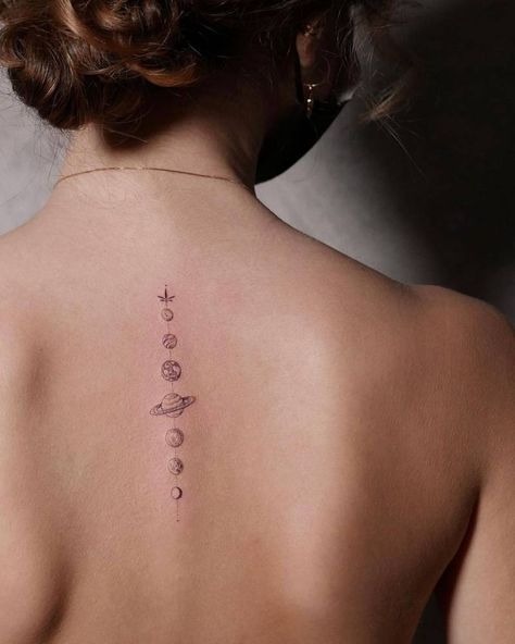 Single needle solar system tattoo on the upper back Subtle Space Tattoo, Universe Tattoo Back, Universe Inspired Tattoos, Solar Tattoo Designs, Universe Spine Tattoo, Fine Line Solar System Tattoo, Small Solar System Tattoo, Spine Tattoos Space, Planets Spine Tattoo