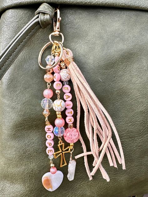 These handmade beaded keychains  are uniquely designed with high-quality beads, offering both style and functionality as a decorative accessory. This item is a great decor piece for your purse, wallet, dash mirror, keys, etc. Beautiful Faith Inspired Faith, Hope, and Love keychain with a cross charm.  A go-to gift for bridesmaids, Christian Women, or birthday gifts.  An awesome way to enhance the look of your favorite purse/bag/pocketbook! Looks fantastic with leather and just as nice with fabric.  These are a truly amazing addition to bridesmaid proposals, make great mother's day gifts, team gifts, teacher gifts and so much more! I would be happy to work with you if you have a specific personalization that isn't listed. Please message me via through my shop to work on an idividualized ite Purse Bead Charm, Purse Charms Diy How To Make, Beaded Keychain Ideas, Beaded Car Charms, Purse Charms Diy, Keychain Beaded, Purse Decorations, Leather Fob, Purse Keychain