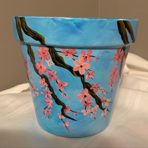 Acrylic on clay pot Pots Painting, Diy Cement Planters, Pots Diy, Diy Cement, Plant Pot Design, Cherry Blossom Painting, Pot Painting, Painted Pots Diy, Painted Clay Pots