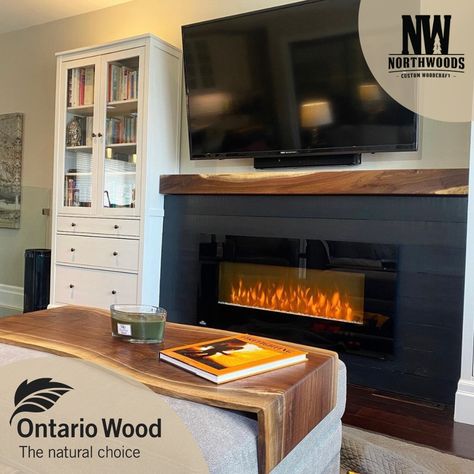 A living room with a fireplace and a flat screen tv, alongside the Ontario Wood logo and the Northwoods Custom Woodcraft logo. Custom Fireplace Mantle, Custom Fireplace, Closet Remodel, Black Walnut Wood, Ottoman Table, Fireplace Mantle, Black Walnuts, Black Walnut, Table Set