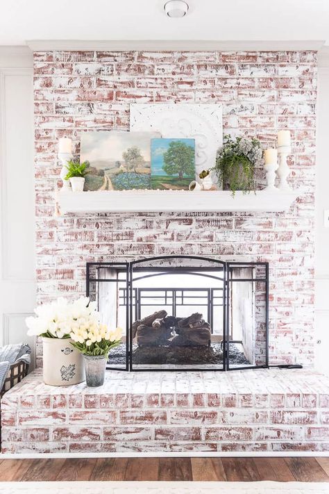 Spring mantel with vintage oil paintings, tulips and greenery Coastal Mantle, White Pots, Spring Mantle, French Coastal, Blush Pillows, Painted Candlesticks, Rustic Mantel, Paint Fireplace, Spring Centerpiece