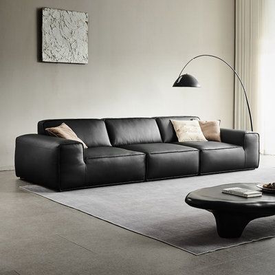 Introducing our modern and minimalist black cushioned leather sofa, the epitome of elegance and sophistication. Made with high-quality top-grain leather that is waterproof, dirt-resistant, soft, breathable, and durable. The seat is filled with high-resilience foam, down, and synthetic fibers, providing a comfortable sitting experience that retains its shape and support over time. The backrest is also filled with high-resilience foam, down, and synthetic fibers, ensuring a plush and comfortable f Black Leather Sofa Living Room, Black Sofa Living Room Decor, Black Sofa Living Room, Black Leather Couch, Trendy Sofas, Leather Sofa Living Room, Home Decor Catalogs, Modern Leather Sofa, Black Leather Sofas