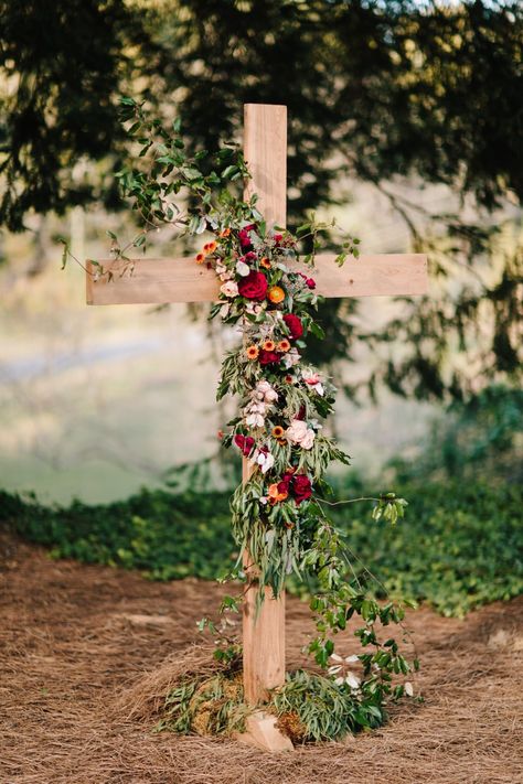 Wood Cross with a floral garland featured a mixed variety of foliage for texture and burgundy, rust oranges, and some light peach flowers. @anik_flowers; Laura Burchfield Events Ben;  Collen Wedding Photography Wedding Cross Altar, Cross Wedding Backdrop, Flowers On Cross, Dekor Nikahan, Wedding Core, Cross Flowers, Wedding Alters, Fun Wedding Decor, Wedding Isles