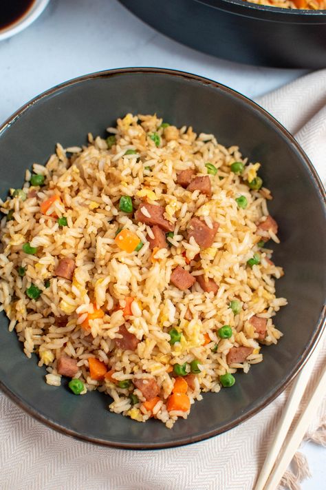 Here’s how to make quick, easy, and delicious Hawaiian-inspired Spam Fried Rice in just 35 minutes! It’s the perfect lunch or dinner recipe and a great way to use leftover rice. This simple dish features canned spam, peas, eggs, and carrots in a savory sauce. So good! Fried Rice With Meat, Spam Rice Recipe, Spam Rice Bowl, Spam Recipes Dinners Easy, Spam And Rice, Asian Crockpot Chicken, Spam Fried Rice Recipe, Spam Recipes Dinners, Use Leftover Rice