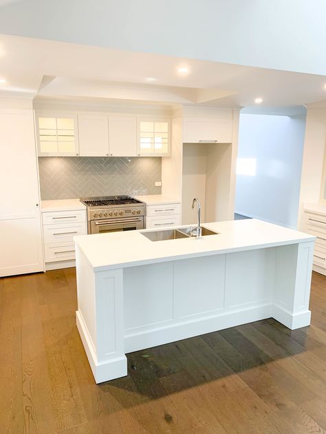 White Hamptons kitchen with island and herringbone splashback. Hamptons Kitchen Splashback, White Hamptons Kitchen, Herringbone Splashback, Coastal Inspired Kitchens, Hampton Kitchen, Hamptons Kitchen, Hamptons Modern, Modern Hampton, Kitchen With Island