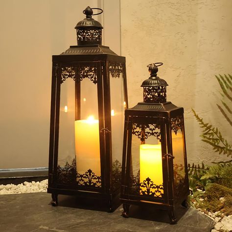 PRICES MAY VARY. Suitable for Most Outdoor Scenes——The set of 2 vintage candle lantern is perfect for outdoor use. The metal material can withstand wind and rain, while the high-quality glass prevents rainwater from getting in and allows you to see the bright, flickering candles, creating a fantastic atmosphere. Inspired Design——The combination of multiple sets adds a variety of possibilities to your home decor. The antique metal paint and high grade exquisite grain design combined with black an Large Floor Lanterns, Large Outdoor Lanterns, Large Candle Lanterns, Farmhouse Front Porch Decor, Floor Lantern, Farmhouse Front Porch, Zen Home Decor, Lantern Ideas, Large Lanterns