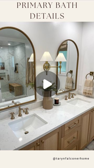 Taryn Falconer on Instagram: "PRIMARY BATHROOM DETAILS🫶🏼One of my favourite transformations last year was the primary bathroom. Details; •White oak vanity with quartz countertop •Champagne bronze fixtures •Ceramic (marble look) oversized tiles •Hexagon (marble look) glass tiles •Roman shades with remote •Arched mirrors •Tumbled brass towel hooks and rings •Teak shower bench •8.66” rain shower head •12” rain shower head •Marble and matte black door knob To SHOP this space head to my stories now or click the link in bio for my LTK! Follow me @tarynfalconerhome for more! Shop my home and get exclusive app only content by following me on LTK and AMAZON, link in bio! • • • #primarybathroom #bathroomdesign #neutralhome #transitionalmodern #homeinspo #luxurybath #masterbathroom #remod Champagne Bronze Bathroom Fixtures, Champagne Bronze Bathroom, Arch Mirror Bathroom, Bronze Bathroom Fixtures, Black Bathroom Fixtures, Front Room Decor, Teak Shower Bench, Bathroom Details, Bronze Fixtures