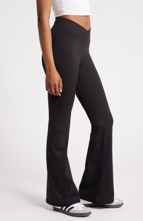 Strike your best pose in these stretchy yoga pants designed with a crossover waistband and flared hems. 32" inseam; 22" leg opening; 10 1/2" front rise; 14" back rise (size Medium) 82% polyester, 18% spandex Machine wash, tumble dry Imported Yoga Flare Pants, Flare Yoga Pants, Good Poses, Pants Design, Nordstrom Store, Fabric Gifts, Free Fabric, Black Fits, Flare Pants