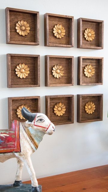 Mitesh | Home & Design on Instagram: "This was such an easy project with a big impact. I found these small wood plaques at the $1 bin @michaelsstores and knew they would work great for what I had in mind. I stained them in a walnut color along with wood rosettes from @amazon. I finished off the rosettes with RubnBuff in antique gold to give it the look of antique brass. Then they were ready for the wall. I grouped together 9 but you could do any number of arrangements. I wanted it to kind of loo Diwali Shoot, Diy Ideas For Home, Wooden Shelf Design, Wood Rosettes, Brass Wall Art, Indian Wall Decor, Shelves Design, Plaque Design, Antique Wall Decor