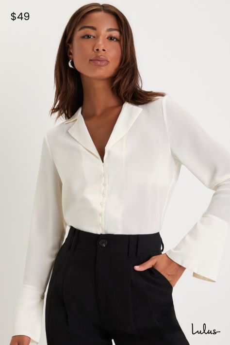 You'll be impressing all around the office in the Lulus Sophisticated Presence Ivory Collared Long Sleeve Button-Up Top! Lightweight woven chiffon shapes this chic top that has long sleeves with oversized, flaring cuffs that have decorative buttons. Collared neckline boasts notched lapels, atop a bodice with a functional loop-button placket at front. Rounded hems complete the look. Fit: This garment fits true to size. Length: Size medium measures 26.25" from shoulder to hem. Bust: Great for any cup size. Waist: Not Fitted - comfortable room throughout midsection. Undergarments: May be worn with any standard bra. Fabric: Fabric has no stretch. Unlined. 100% Polyester. Hand Wash Cold. Do Not Bleach. Line Dry. Iron Low Heat. Imported. Lulus | Sophisticated Presence Ivory Collared Long Sleeve Long Sleeve Business Casual, Old Money Blouse, Notched Collar Shirt, Professional Blouse, Notch Collar Shirt, Professional Blouses, Dream Ideas, Ivory Blouse, Collared Top