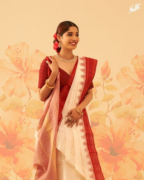 Presenting 𝐍𝐚𝐮𝐫𝐚𝐭𝐚𝐧
Colourful Silk Sarees Designed for Joyful Festivities💫

The auspicious white colour represents peace and spirituality, this Kanchipuram Cotton saree is elevated with a scintillating silk temple border. 💫 Bangali Saree Style Saris, Saree White And Red, Bangla Culture, Saree Styling Ideas, Red And White Saree, Saree White, Draping Styles, Saree Styling, Saree Drape